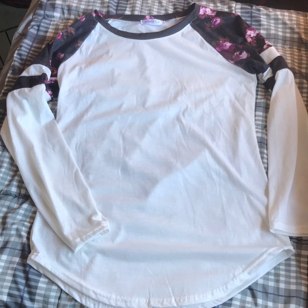 3/$15. Long sleeved cotton feel tee with floral accent